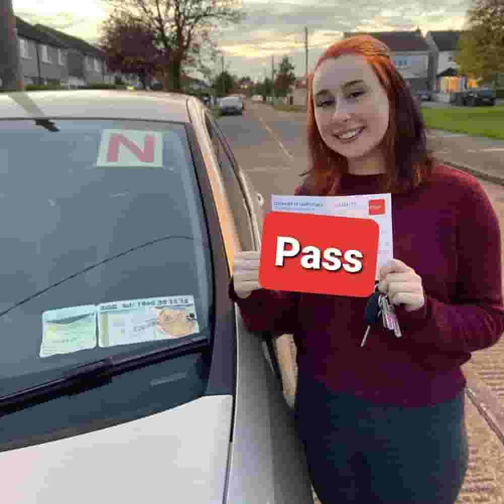 girl on bonet of car holding license